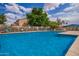 Bright community pool featuring clear blue water, lounge chairs and secure fencing in an inviting outdoor space at 125 S 56Th St # 100, Mesa, AZ 85206