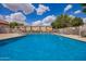 Stunning community pool with clear blue water and comfortable lounge chairs surrounded by secure fencing for resident relaxation at 125 S 56Th St # 100, Mesa, AZ 85206