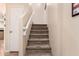 A carpeted staircase leads to the upper floor at 125 S 56Th St # 100, Mesa, AZ 85206