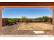 View of backyard featuring desert landscaping and a covered patio at 13749 W Amberwing St, Peoria, AZ 85383