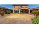 Backyard features desert landscaping, a patio, and a block wall at 13749 W Amberwing St, Peoria, AZ 85383