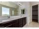 Bathroom features dual sinks, dark wood cabinetry, and a separate glass shower and tub at 13749 W Amberwing St, Peoria, AZ 85383