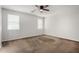 Neutral bedroom with a ceiling fan and two windows providing natural light at 13749 W Amberwing St, Peoria, AZ 85383