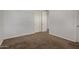 Bedroom featuring neutral carpeting and a closet with folding doors at 13749 W Amberwing St, Peoria, AZ 85383