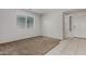 Bright bedroom with a neutral color scheme, plush carpeting, and a large window at 13749 W Amberwing St, Peoria, AZ 85383