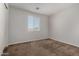 Bright bedroom featuring neutral carpeting and a window with white blinds at 13749 W Amberwing St, Peoria, AZ 85383
