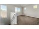 Spacious carpeted bonus room with bright, natural light and neighborhood views at 13749 W Amberwing St, Peoria, AZ 85383