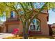 Charming two-story home featuring a well-manicured front yard and a two car garage at 13749 W Amberwing St, Peoria, AZ 85383
