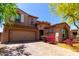 Charming two-story home featuring a well-manicured front yard and a two car garage at 13749 W Amberwing St, Peoria, AZ 85383
