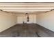Spacious garage with a concrete floor, shelving, and a door to the home's interior at 13749 W Amberwing St, Peoria, AZ 85383