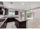 Modern kitchen features dark wood cabinets, granite countertops, and a functional kitchen island at 13749 W Amberwing St, Peoria, AZ 85383