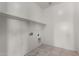 Bright laundry room with neutral tile floors and shelving for storage at 13749 W Amberwing St, Peoria, AZ 85383