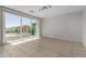 Expansive living area with tile floors, a modern light fixture, and large sliding glass doors at 13749 W Amberwing St, Peoria, AZ 85383
