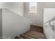 Carpeted stairs with a white railing and a window at 13749 W Amberwing St, Peoria, AZ 85383