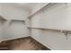 Walk-in closet featuring ample shelving and rod space for organized storage at 13749 W Amberwing St, Peoria, AZ 85383