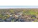 Expansive aerial view of a golf course community with lush greenery and mountain views in the distance at 13841 W Nogales Dr, Sun City West, AZ 85375