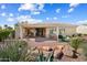 The home's rear exterior offers a covered patio and landscaped backyard with desert plants at 13841 W Nogales Dr, Sun City West, AZ 85375