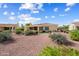 Rear exterior of house with desert landscaping, covered patio, and views of the putting green at 13841 W Nogales Dr, Sun City West, AZ 85375