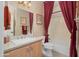 Bathroom featuring a vanity, sink, and bath with shower with red curtains at 13841 W Nogales Dr, Sun City West, AZ 85375