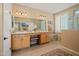 Bathroom with double sinks, vanity, tub, tiled floors and step in shower at 13841 W Nogales Dr, Sun City West, AZ 85375