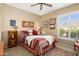 Cozy bedroom featuring a comfortable bed, shuttered windows, and natural light at 13841 W Nogales Dr, Sun City West, AZ 85375