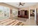 Spacious bedroom featuring shuttered windows, ceiling fan, and built-in shelving at 13841 W Nogales Dr, Sun City West, AZ 85375