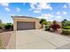 Charming home featuring a two-car garage, desert landscaping, and lush colorful shrubs at 13841 W Nogales Dr, Sun City West, AZ 85375