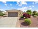 Charming home exterior featuring a two-car garage and vibrant desert landscaping at 13841 W Nogales Dr, Sun City West, AZ 85375