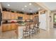 Spacious kitchen with a breakfast bar, stainless steel appliances, and generous cabinet storage at 13841 W Nogales Dr, Sun City West, AZ 85375