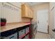 Well-organized laundry room with cabinets, counter space, and modern appliances at 13841 W Nogales Dr, Sun City West, AZ 85375
