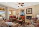 Inviting living room features a cozy fireplace, plush seating, and a ceiling fan for added comfort at 13841 W Nogales Dr, Sun City West, AZ 85375