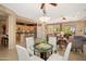 Open-concept living room with kitchen access, plenty of seating, and natural light at 13841 W Nogales Dr, Sun City West, AZ 85375
