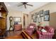 Inviting living room featuring hardwood floors, cozy seating, and ample natural light at 13841 W Nogales Dr, Sun City West, AZ 85375