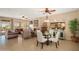 Spacious living room featuring tile flooring, a ceiling fan, and access to the back patio at 13841 W Nogales Dr, Sun City West, AZ 85375