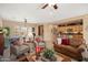 Open-concept living space with a cozy sitting area, adjacent dining area, and a glimpse into the kitchen at 13841 W Nogales Dr, Sun City West, AZ 85375