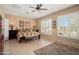 Serene main bedroom with plantation shutters, a ceiling fan, and neutral tones for a peaceful retreat at 13841 W Nogales Dr, Sun City West, AZ 85375