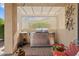 Covered outdoor kitchen boasts a stainless steel grill and desert-themed metal art at 13841 W Nogales Dr, Sun City West, AZ 85375