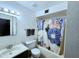Bright bathroom featuring floral shower curtain, toilet, and vanity sink at 141 N Date -- # 7, Mesa, AZ 85201