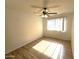 Bedroom features wood-look floors, a ceiling fan, and a window for natural light at 141 N Date -- # 7, Mesa, AZ 85201