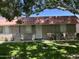 Charming single-story home with a red tile roof, well-maintained lawn, and mature shade trees in a desirable neighborhood at 141 N Date -- # 7, Mesa, AZ 85201