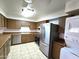 Functional kitchen featuring stainless steel appliances, wood cabinets, and a stacked washer and dryer at 141 N Date -- # 7, Mesa, AZ 85201