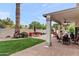 Lush backyard with covered patio, fire pit, and a seating area, great for outdoor entertaining at 1515 E Saratoga Ct, Gilbert, AZ 85296