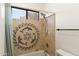 Bright bathroom with tile shower featuring dolphin design, window and brushed nickel shower head at 1515 E Saratoga Ct, Gilbert, AZ 85296