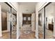 Gorgeous bathroom featuring a stone wall with jacuzzi tub, mosaic tile floors, and mirrored doors at 1515 E Saratoga Ct, Gilbert, AZ 85296
