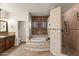 Elegant bathroom boasts a jetted tub with stone accent, and a walk-in shower with beautiful tile work at 1515 E Saratoga Ct, Gilbert, AZ 85296