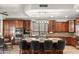 Gourmet kitchen featuring custom cabinets, granite countertops, stainless steel appliances, and a central island with seating at 1515 E Saratoga Ct, Gilbert, AZ 85296