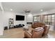 Inviting living room with modern flooring, a fireplace, media center and comfortable leather seating at 1515 E Saratoga Ct, Gilbert, AZ 85296