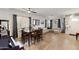 Spacious living room featuring wood floors, large windows, and a comfortable seating area at 1515 E Saratoga Ct, Gilbert, AZ 85296