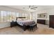 Spacious main bedroom with a ceiling fan, dark wood furniture, and lots of natural light from the windows at 1515 E Saratoga Ct, Gilbert, AZ 85296