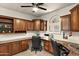 Spacious home office with custom cabinetry, a ceiling fan and large window creates a productive workspace at 1515 E Saratoga Ct, Gilbert, AZ 85296